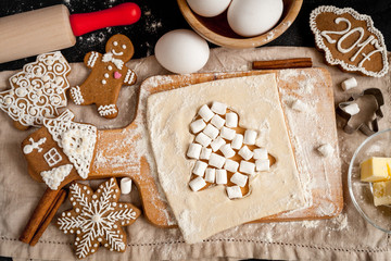 cooking christmas gingerbread on wooden background top view