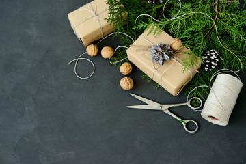 Wrapping rustic eco Christmas packages with brown paper, string