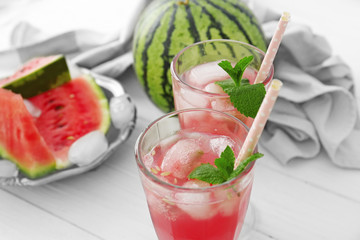 Watermelon with cocktails on light background