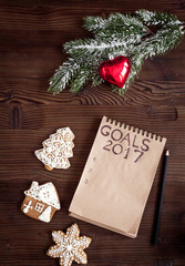 notebook and goals for new year wooden background top view