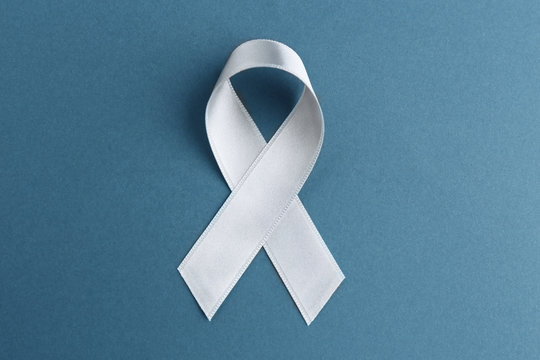 Grey ribbon on grey background. Brain cancer, diabetes, asthma concept