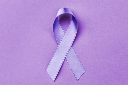 Lavender ribbon on color background. Cancer and epilepsy concept