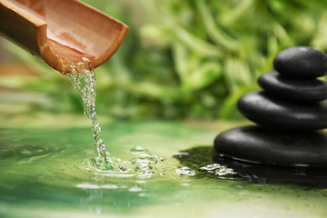 Beautiful spa composition with pouring water and stones
