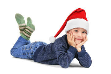 Cute little boy in Santa hat on white background