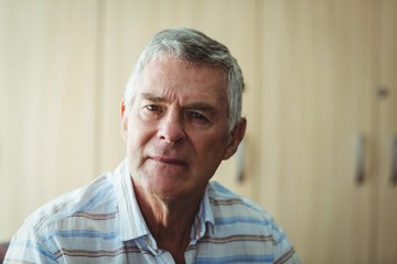 Portrait of senior man in living room