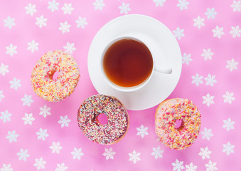Cup of tea for breakfast with donuts in motion