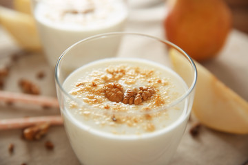 Tasty milk shake with walnut on table