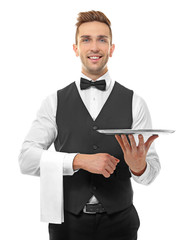 Handsome young waiter with metal tray on white background