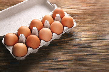 Eggs package on wooden background