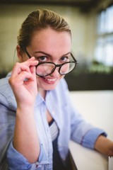 Businesswoman adjusting eyeglasses
