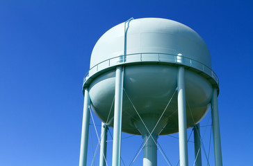 Water tower with blue sky in the background  - Powered by Adobe
