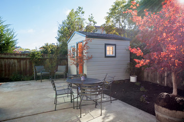 Yard with garden and shed and seating arrangement.