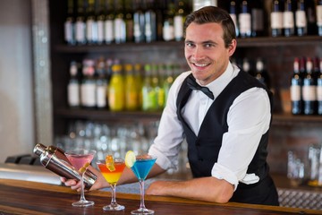 Bartender mixing a cocktail drink in cocktail shaker