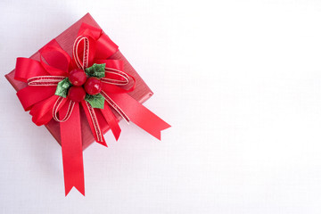 Christmas and happy new year giftbox with red satin ribbon bow