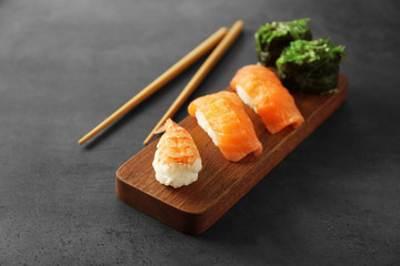 Delicious sushi set on wooden board