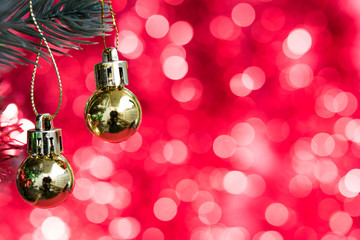 Christmas ornaments decorate on fir tree with gold bokeh