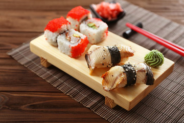 Delicious sushi set on wooden board