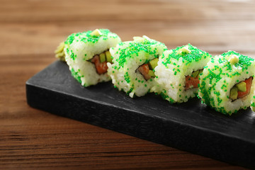 Delicious sushi set on wooden board