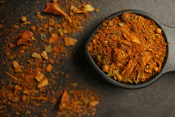 Different spices in spoon on table