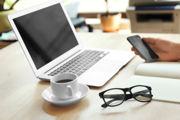 Businessman working place with laptop, glasses and cup of coffee