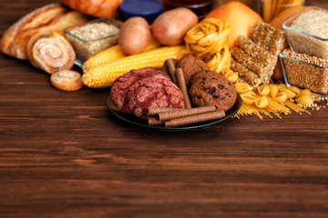 Assortment of delicious products on wooden background