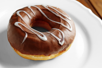 Tasty donut on plate, closeup
