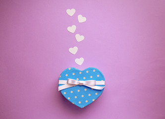 Heart shaped gift box on lilac background