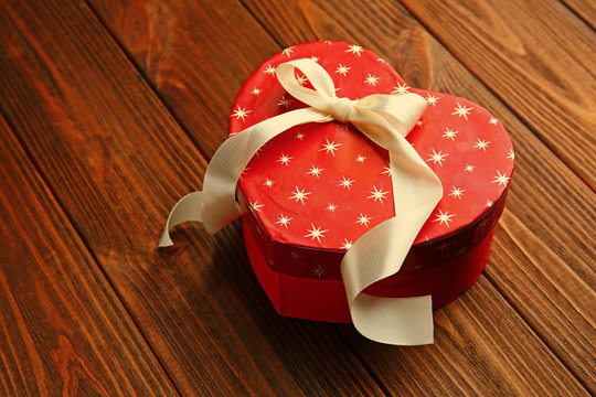 Heart shaped gift box on wooden table