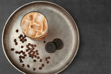 Iced coffee and cookie on silver plate