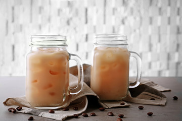 Iced coffee with milk in jars on napkin