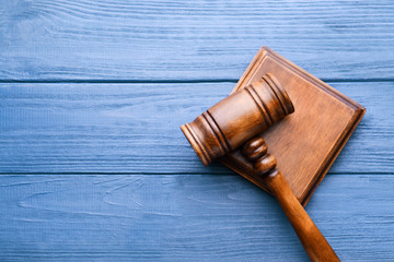 Judge's gavel and sound block on wooden background, top view