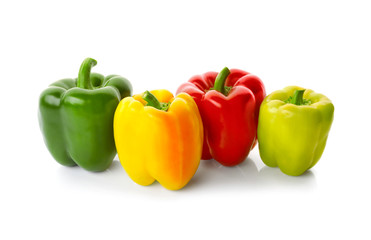Set of sweet red, yellow and green peppers on white background