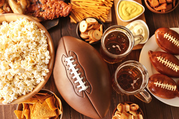 Table full of tasty snacks and beer prepared for watching rugby on TV - 128814032
