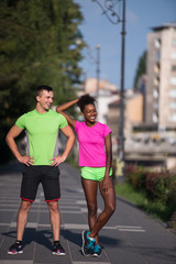 portrait of young multietnic jogging couple ready to run