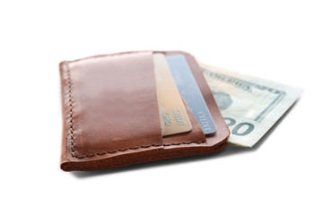 Brown leather wallet with credit cards and money isolated on white