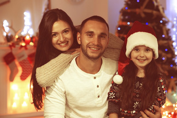 Obraz na płótnie Canvas Happy family in living room decorated for Christmas