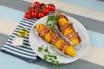 Grilled corns with beacon on plate