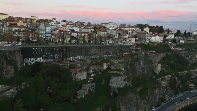 Subway train passing in a tunnel. Twilight view on the bank of the Dora river in Porto, Portugal.