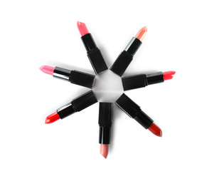 Assortment of lipsticks on white background, top view