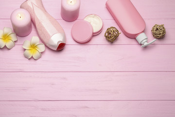 Spa treatments on pink wooden background