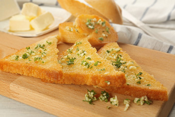 Garlic French bread slices on wooden board