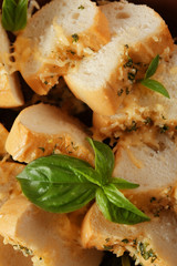 Slices of tasty bread with garlic and herbs, close up