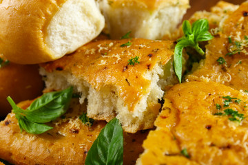 Tasty bakery products with garlic and herbs, close up view
