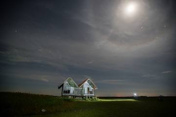Dilapidated of landmark house at Talaynoi in magic night with moon corona or halo phenomenon over...