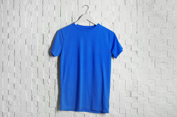 Blank blue t-shirt against light textured background