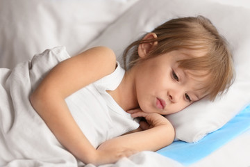 Fototapeta na wymiar Small sick girl on bed