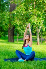 Yoga woman on green grass