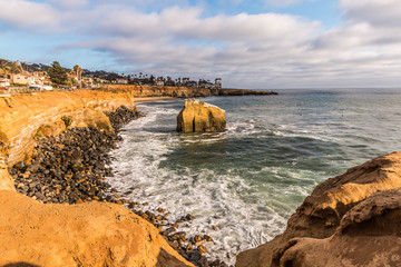 Golden sunset light shining on Bird Rock at Sunset Cliffs in San Diego, California. 