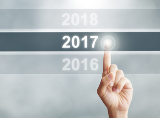 Woman hand pointing new year 2017. Business new year concept.