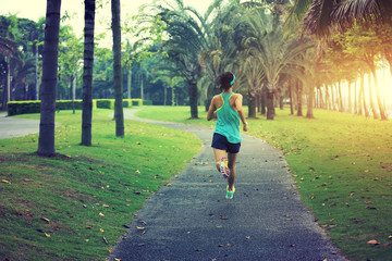 Fototapeta premium healthy lifestyle young sporty asian woman running at tropical park